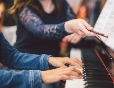 child taking piano lessons